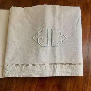 linen sheet on antique bed