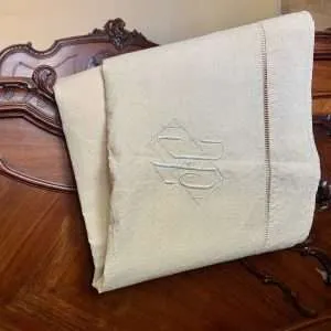 linen sheet on antique bed