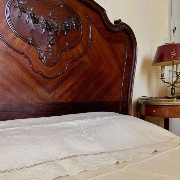 linen sheet on antique bed