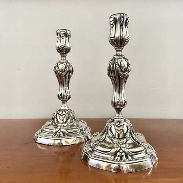 a pair of silvered bronze candlesticks